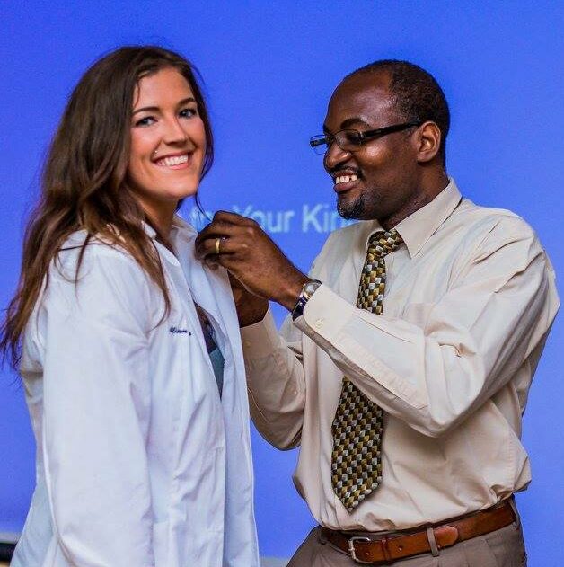 Medical school student being pinned by faculty during 5th term ceremony